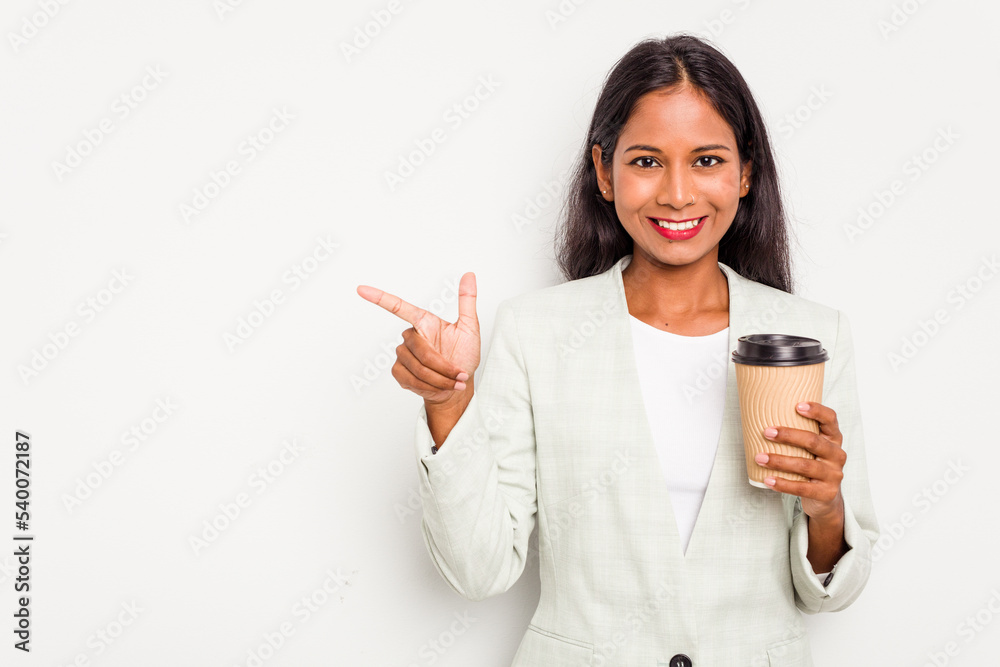Young business Indian woman holding takeaway coffee isolated on white background smiling and pointing aside, showing something at blank space. Young business Indian woman holding takeaway coffee isolated on white background smiling and pointing aside, showing something at blank space.