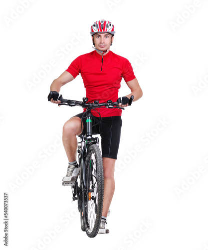 Standing in a studio cyclist holding his foot on the pedal