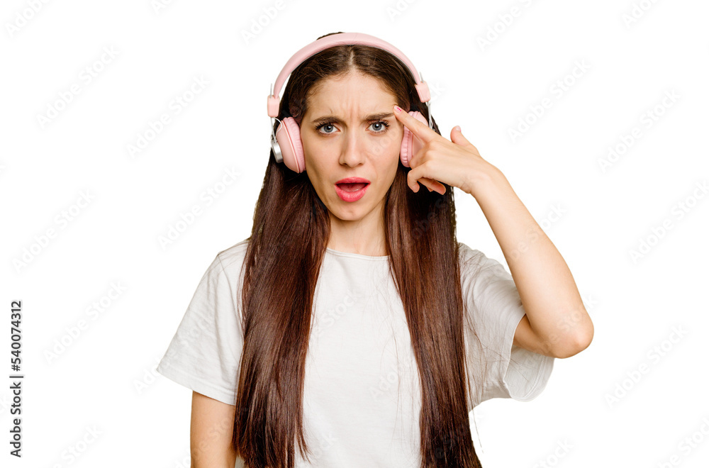 Young caucasian woman wearing headphones isolated showing a disappointment gesture with forefinger. Young caucasian woman wearing headphones isolated showing a disappointment gesture with forefinger.