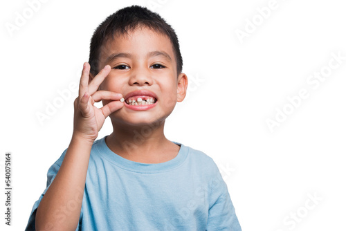 Little boy holding his first falling baby tooth The boy was very proud of his growth