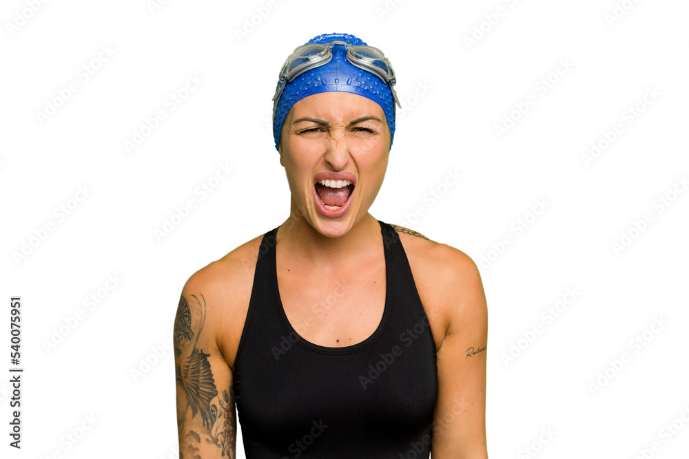 Young caucasian swimmer woman isolated on green chroma background screaming very angry and aggressive.