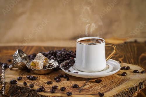 A cup of Turkish coffee on a walnut wood floor, Turkish delight with Turkish pistachio, stillife