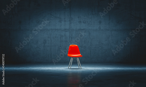 Fototapeta Naklejka Na Ścianę i Meble -  lonely red chair in a concrete room.