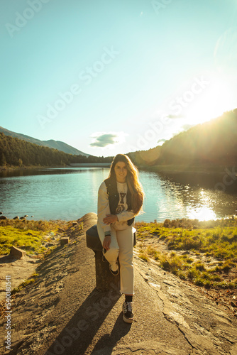 Portrait of a girl smiling at a lake during sunset photo