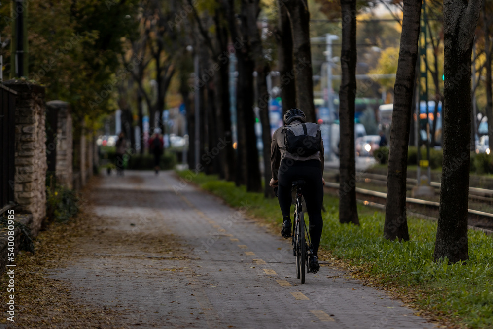 Man riding a bicycle alone in Budapest cycleway