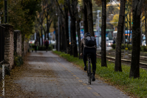 Man riding a bicycle alone in Budapest cycleway