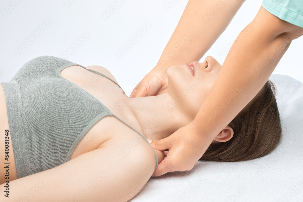 Masseur makes a relaxing massage on the neck, shoulders, back and collarbones of a young beautiful woman in a spa. Treatment for back pain.