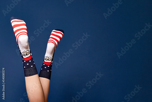 Woman leg in red grey christmas socks.