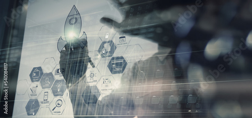 Businessman working on modern computer showing Startup concept with icon business and network connection on modern virtual dashboard.