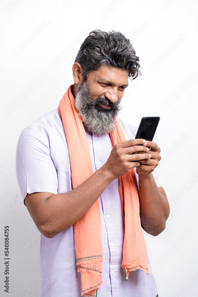 Indian farmer using smartphone on white background. Indian farmer using smartphone on white background.