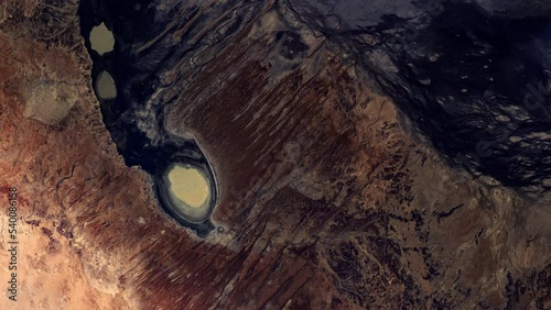 Flying over rock and sand desert Queensland Australia, sunrise animation aerial satellite view from space based on image by Nasa