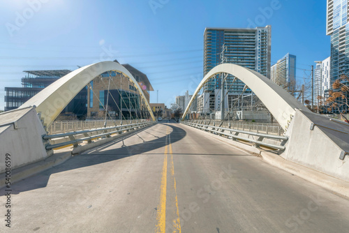Butterfly bridge with view of buildings and blue sky in downtown Austin Texas