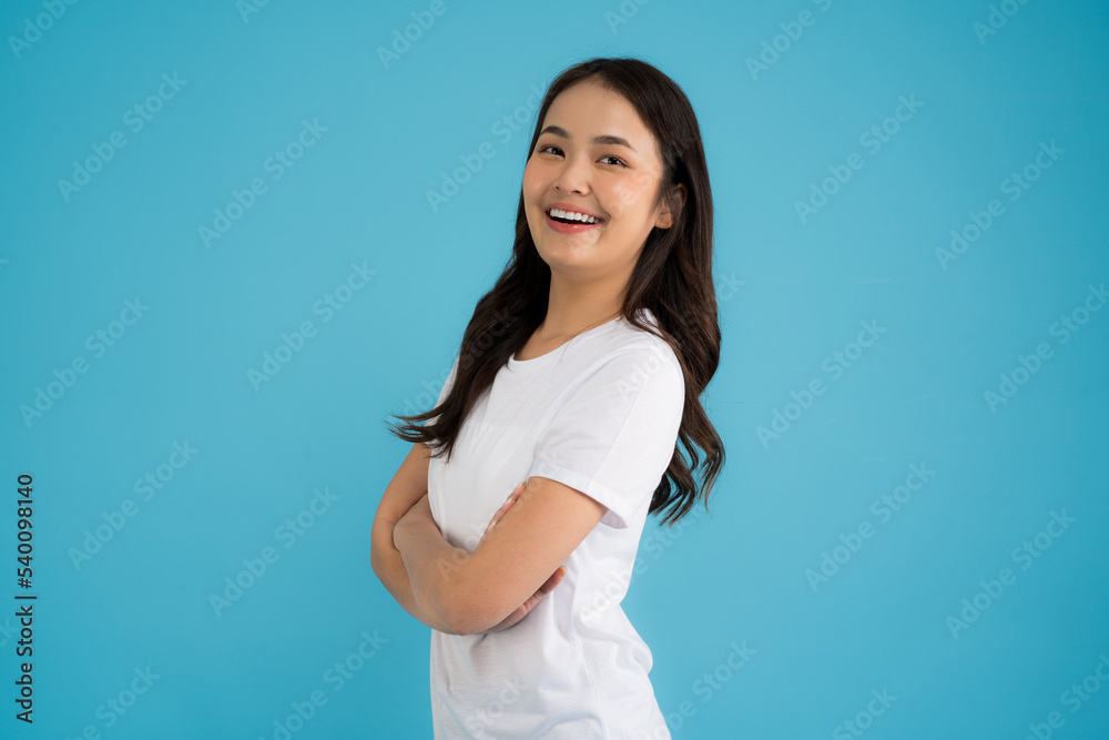 Beautiful Asian woman standing doing various poses on a blue background. Beautiful Asian woman standing doing various poses on a blue background.
