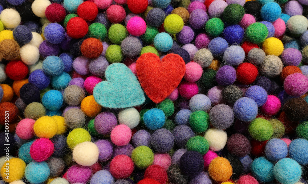 Background of balls of carved wool and two blue and red hearts Background of balls of carved wool and two blue and red hearts