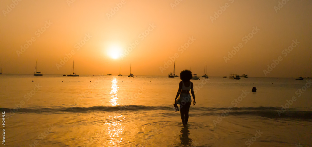 Woman Walking on Beach in Bridgetown Barbados During Sunset