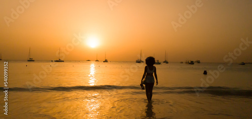 Woman Walking on Beach in Bridgetown Barbados During Sunset