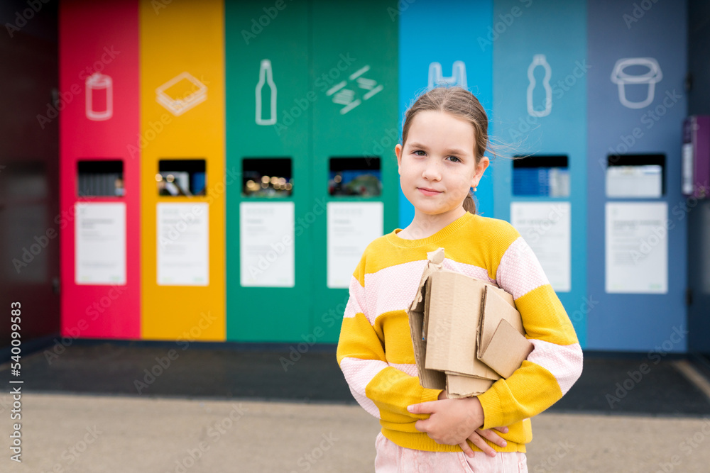 Portrait of girl dumping cardboard in bank for reduce, reuse, recycle