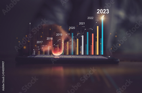 Businessman analyzes performance profitability of working companies with digital augmented reality graphics, positive indicators in 2023, businessman calculates financial data for long-term investment photo