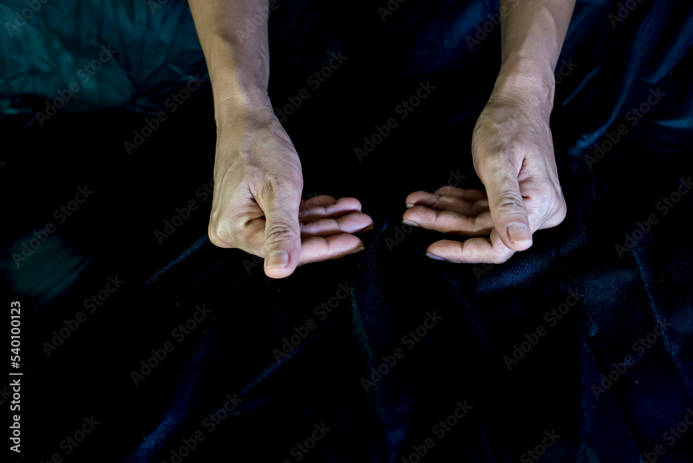 Hand and finger gestures show magic on black background with light and shadow. Look mysterious and hidden. Mysterious.