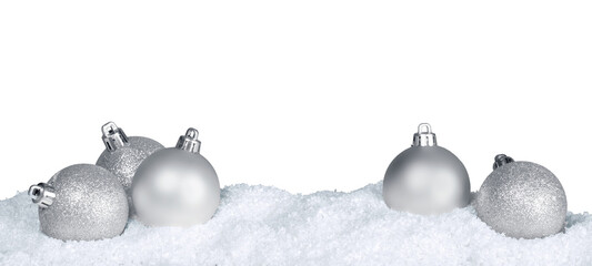 Silver shiny christmas balls in snow isolated on white background. Banner