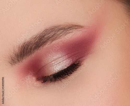 Beautiful eye makeup: Soft pink and shimmery eyeshadow, defined crease, winged eyeliner, long lashes. Perfect for beauty tutorials, makeup inspiration, or social media posts.