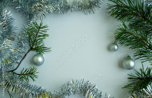 Christmas tree branches, tinsel and Christmas balls.