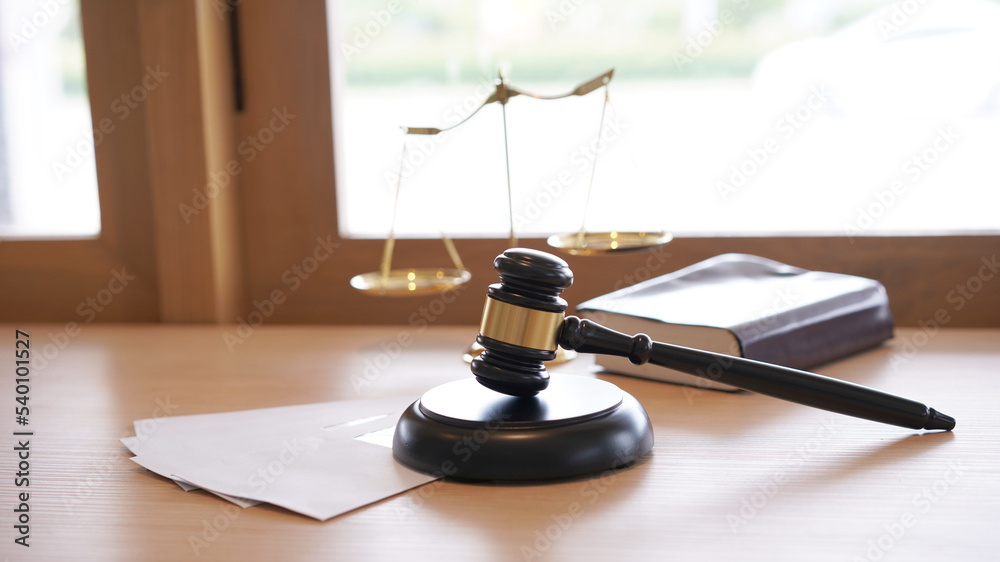 Lawyer or judge's hammer in the court. Auction's hammer and judgement golden scale are on wood table. Law subject. Judgement subject to judge people. Lawyer or judge's hammer in the court. Auction's hammer and judgement golden scale are on wood table. Law subject. Judgement subject to judge people.