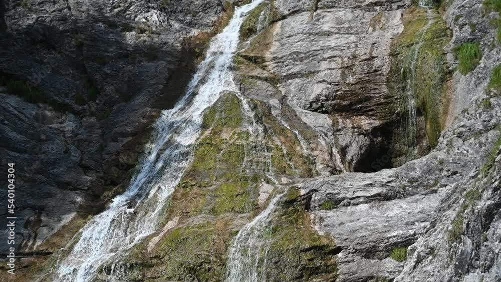 Water flows over mossy rocks in the mountains (slow motion) Water flows over mossy rocks in the mountains (slow motion)