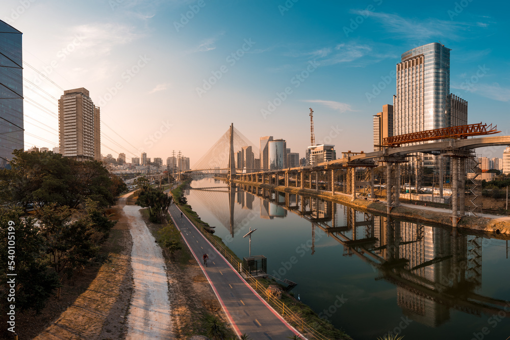 View of Pinheiros River With Modern Buildings Alongside and Famous Octavio Frias de Oliveira Bridge in Sao Paulo City