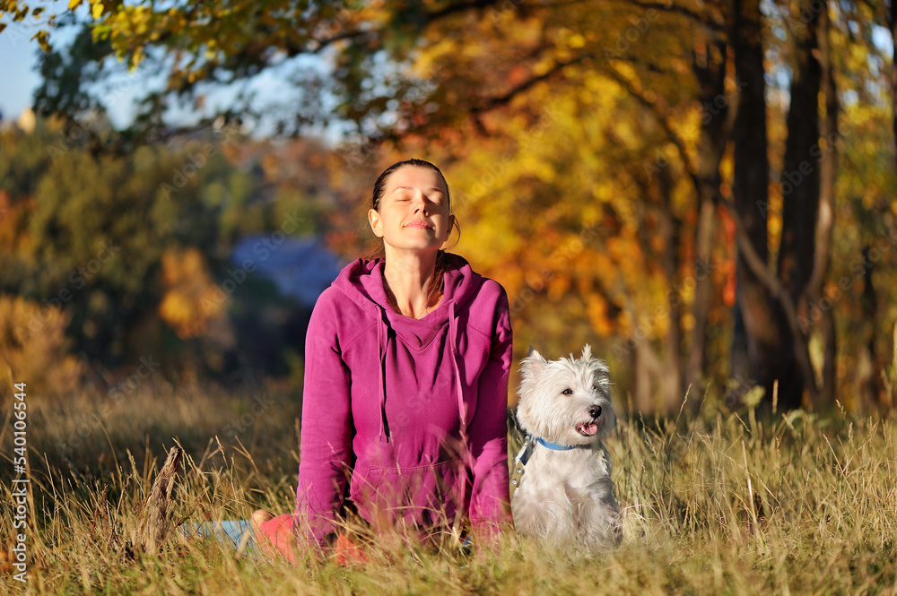 Woman making cora yoga pose with her dog Woman making cora yoga pose with her dog