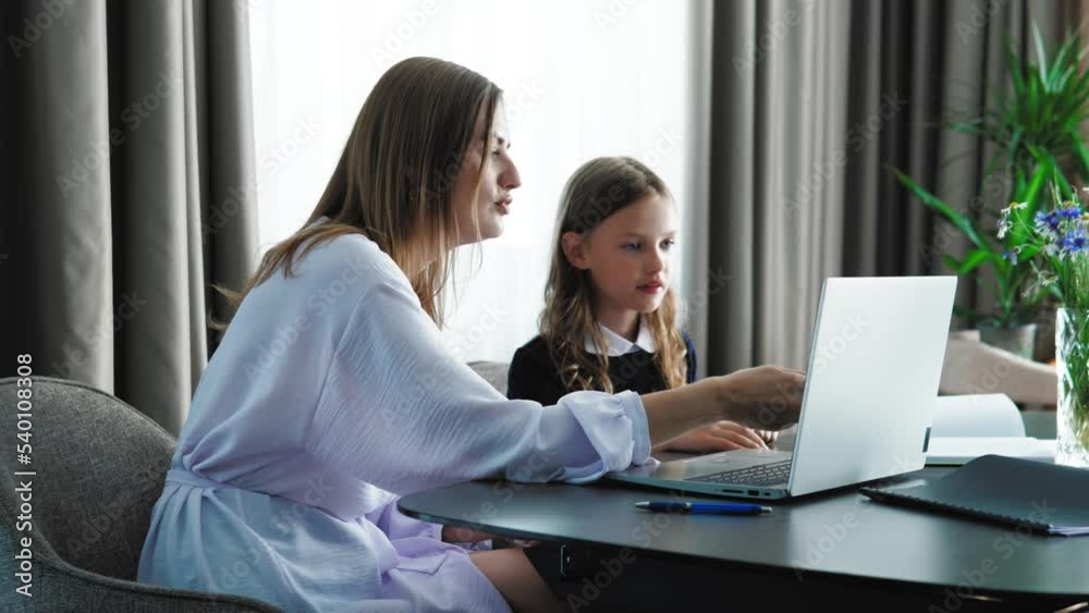 Happy family adult parent mother helping motivating teenage school girl doing homework. Positive mom and teen daughter studying together having fun sitting at home desk in sunny room. Happy family adult parent mother helping motivating teenage school girl doing homework. Positive mom and teen daughter studying together having fun sitting at home desk in sunny room.
