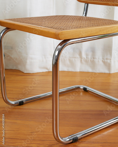 Vintage mid-century modern wooden chrome and cane Cantilever chair, seat and legs detail. photo