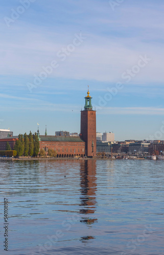 The Town City Hall, reflecting in the calm water of the bay Riddarfjärden a sunny autumn day in Stockholm
