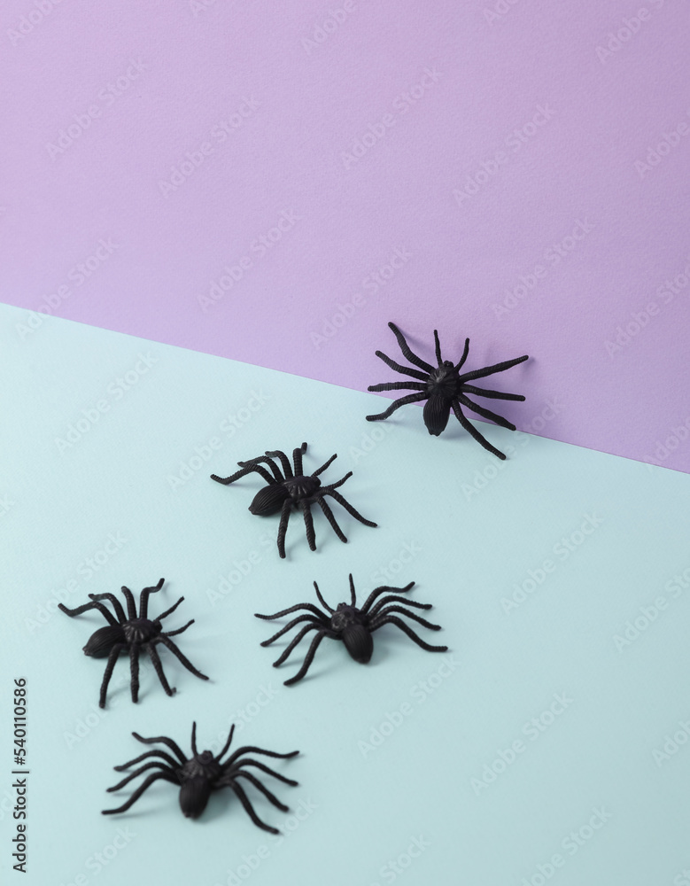 Creative halloween layout with spiders on pastel background. Conceptual pop. Minimal still life