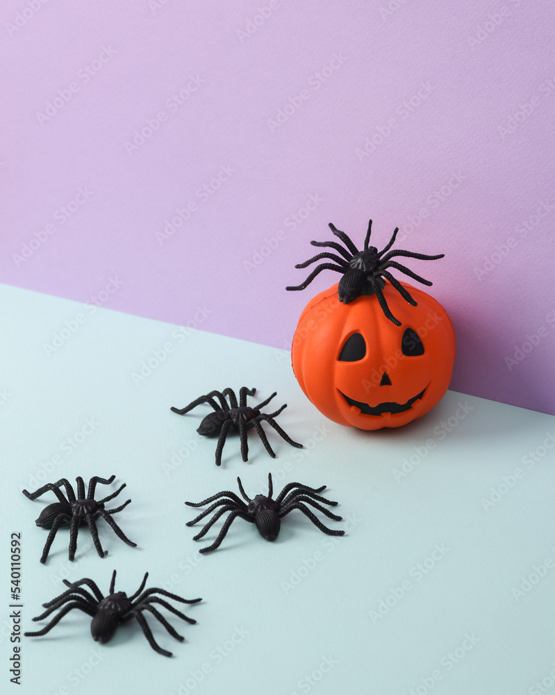 Creative halloween layout with spider and pumpkin on pastel background. Conceptual pop. Minimal still life