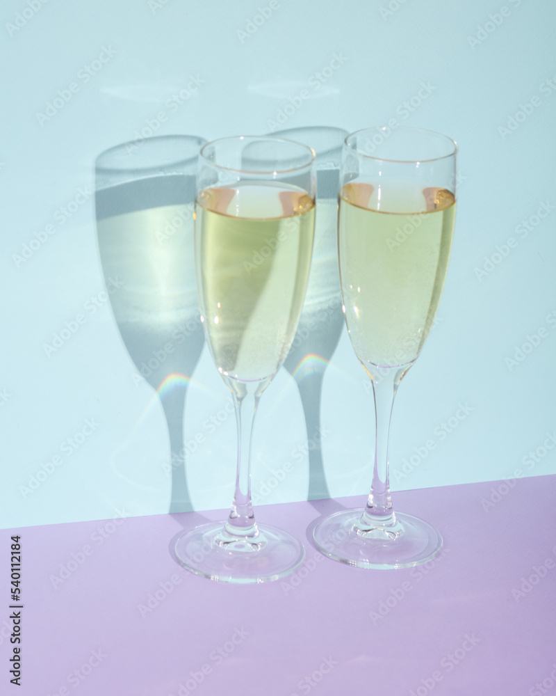 Creative layout with champagne glass on two tone pastel background. Visual trend. Minimalistic aesthetic still life. Romantic date, holiday Creative layout with champagne glass on two tone pastel background. Visual trend. Minimalistic aesthetic still life. Romantic date, holiday