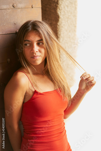 Girl with tight red dress and long straight hair posing in Toledo