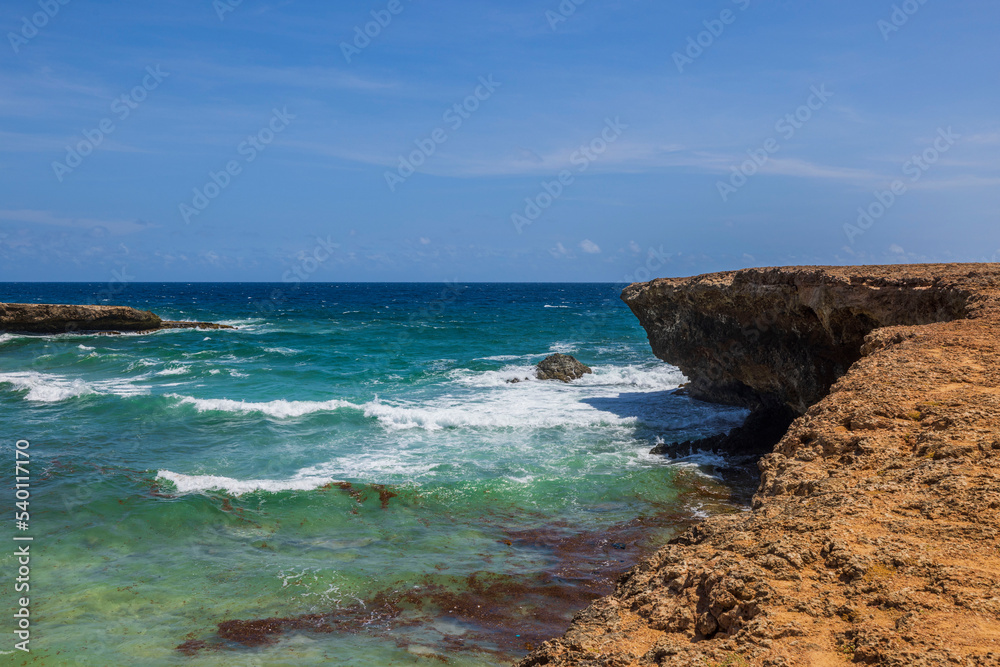 Beautiful view of big turquoise waves on western rocky coast of island of Aruba.