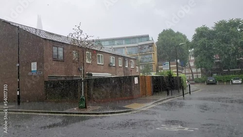 Slow motion of a heavy rain at a housing estate in Bermondsey, London, UK photo
