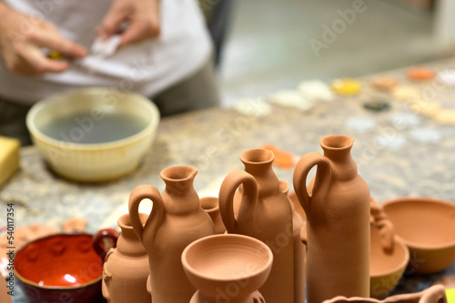 Man professional potter making pottery in his pottery workshop