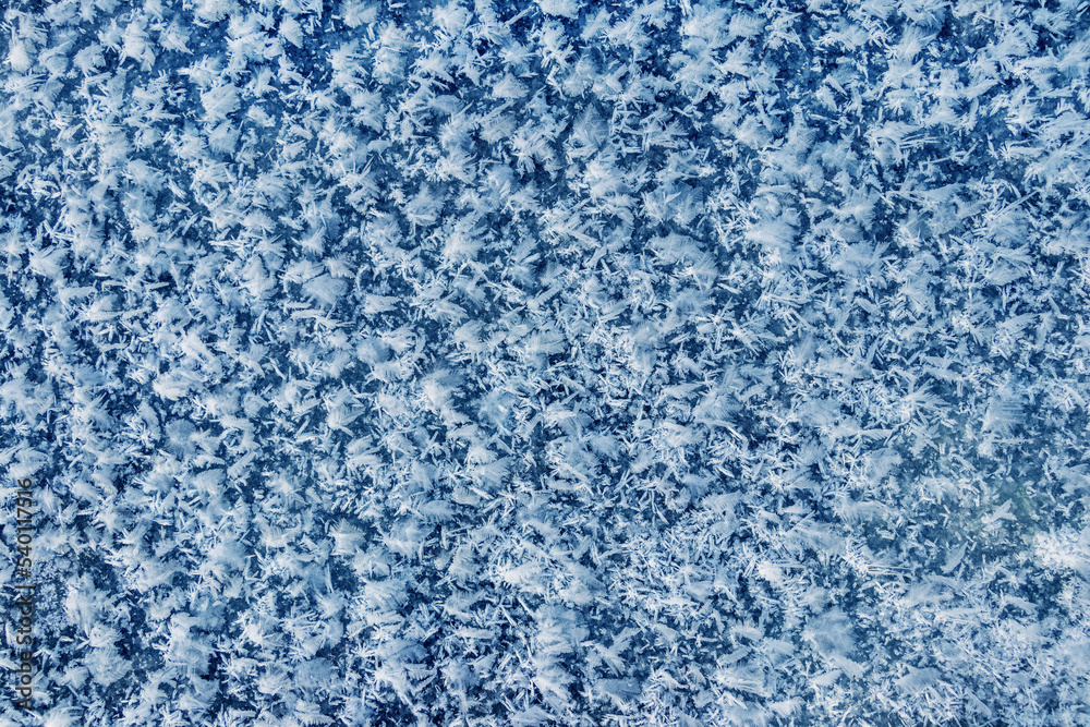 Big fluffy snowflakes on the surface of the ice. Winter and Christmas background Big fluffy snowflakes on the surface of the ice. Winter and Christmas background