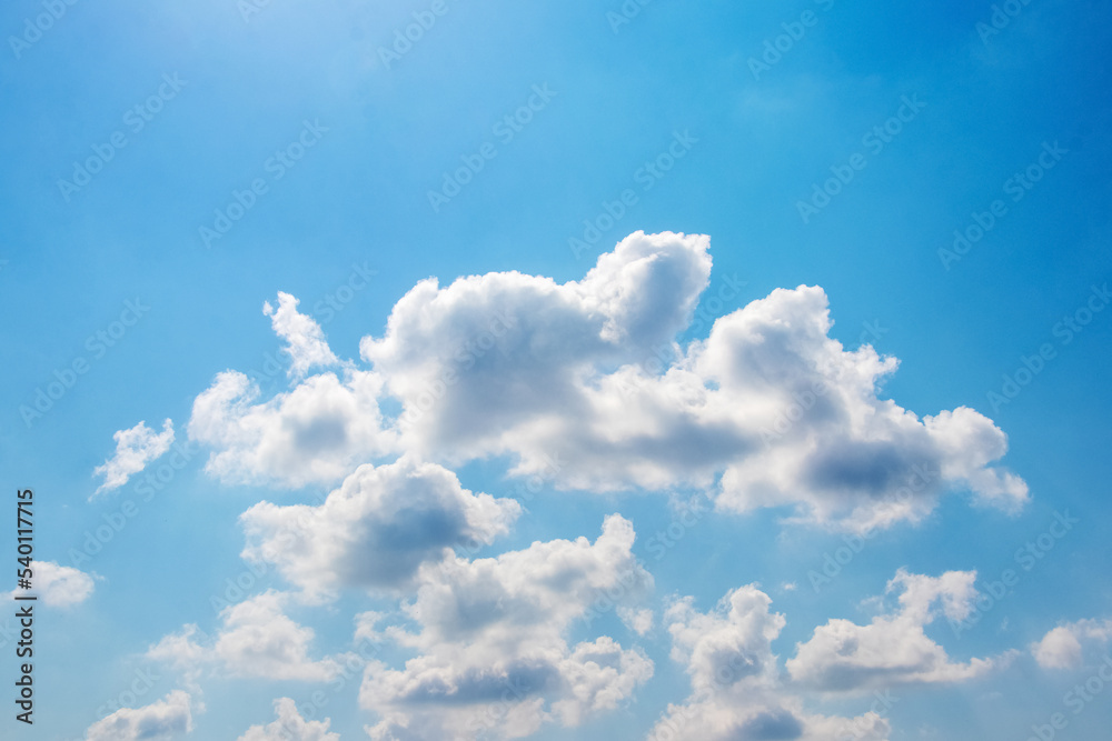 Bright sunlight illuminated white clouds in the blue sky Bright sunlight illuminated white clouds in the blue sky