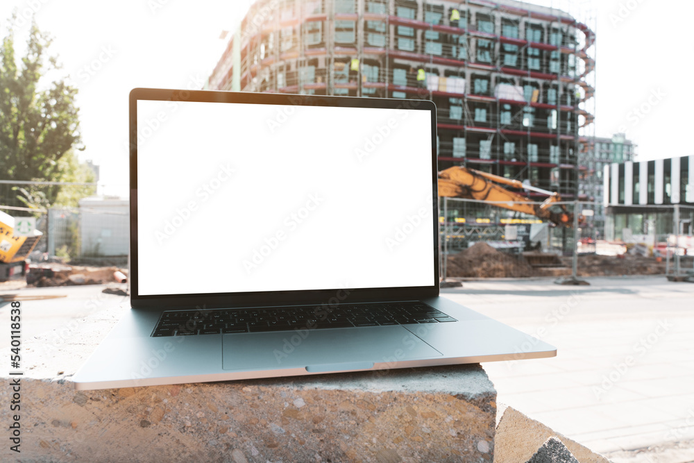 custom made wallpaper toronto digitallaptop mockup. Notebook with white screen with construction background. Urban, and remote work and study concept. Empty copy space, blank screen modern laptop.