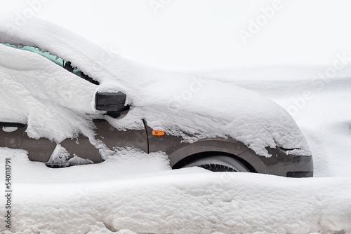 stuck car in snowdrift, passenger car is covered with snow in winter, winter road collapse
