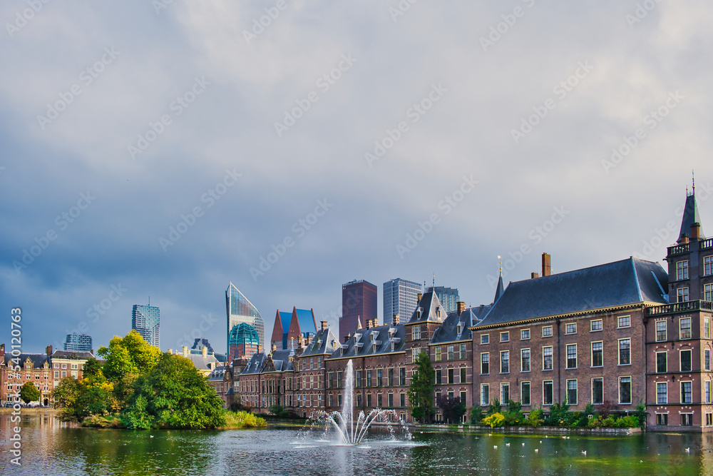 The Dutch Parliament buildings (Binnenhof) with the Hofvijver lake and the skyline of modern buildings in the background, The Hague, the Netherlands
