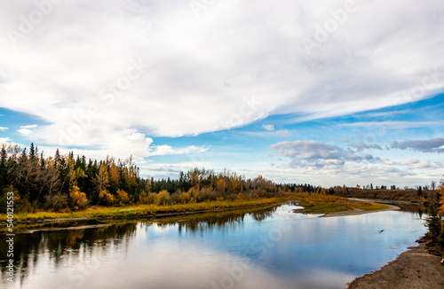 Red Deer River flows past the fall colours. Red Deer County, Alberta, Canada