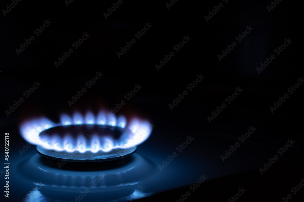 Gas burns with blue flames. Gas crisis around the world. Selective focus on the flame. Soft focus on the picture. Natural gas for housing Gas burns with blue flames. Gas crisis around the world. Selective focus on the flame. Soft focus on the picture. Natural gas for housing