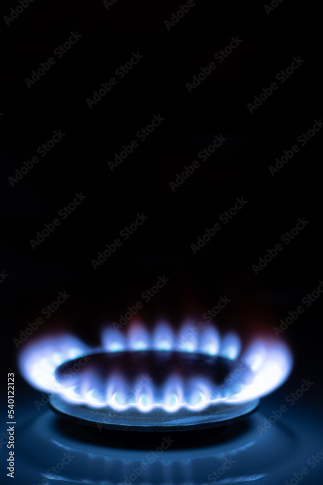 Gas burns with blue flames. Gas crisis around the world. Selective focus on the flame. Soft focus on the picture. Natural gas for housing Gas burns with blue flames. Gas crisis around the world. Selective focus on the flame. Soft focus on the picture. Natural gas for housing