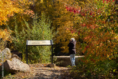 Female Senior Citizen Enjoying the Hobby of Photography during the Fall