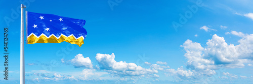 Magallanes Region flag waving on a blue sky in beautiful clouds - Horizontal banner 